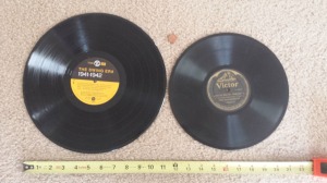 On the left is an LP or Vinyl Record. On the right is a 78 Record. Penny and tape measure used for comparison.